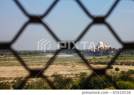 View of Taj Mahal from lattice jali in Agra, Uttar Pradesh, India. It was build in 1632 by Emperor Shah Jahan as a memorial for his second wife Mumtaz Mahal 65818536