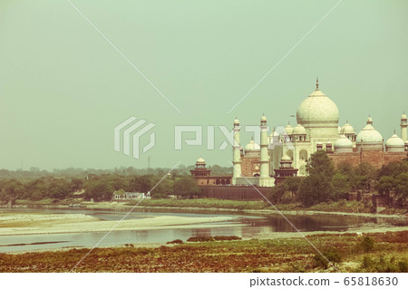 Cross processed vintage retro effect photo of Taj Mahal near yamuna river, Agra, India 65818630