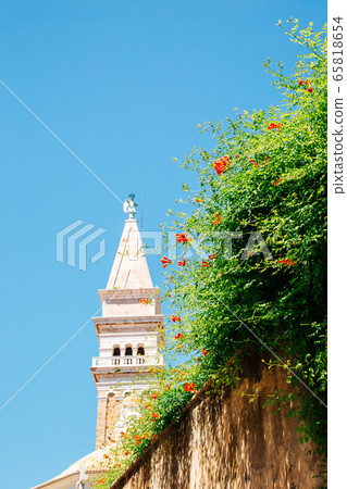 St. George's Parish Church tower with flowers in Piran, Slovenia 65818654