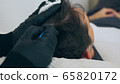 High quality close-up of a man laying on a couch during the esthetician hair treatment. Male tricopigmentation service. Scalp micropigmentation treatment. Trichopigmentation procedure. 65820172