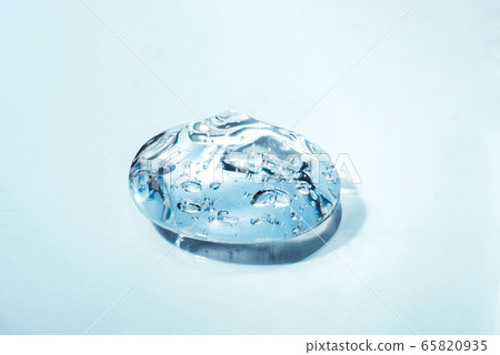 Texture of hyaluronic acid, serum gel, silicone implants, Transparent smear of gel on blue background 65820935