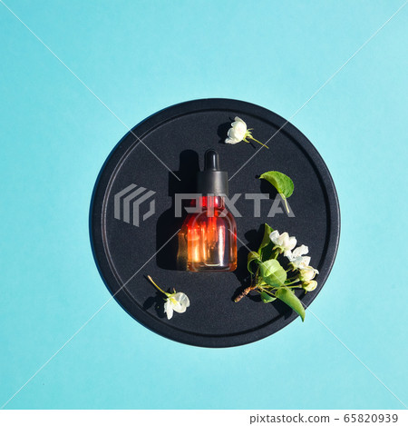 Serum, elixir, perfume for beauty flat lay on blue background. Concept of natural organic cosmetics. Minimalism 65820939
