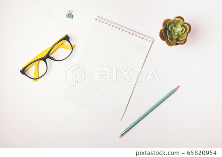 Freelancer workplace top view. Stay at home, work and study online. Notepad, stationery. Light background, flat lay Freelancer workplace top view. Stay at home, work and study online. Notepad, stationery. Light background, flat lay 65820954