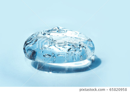 Texture of hyaluronic acid, serum gel, silicone implants, Transparent smear of gel on blue background 65820958