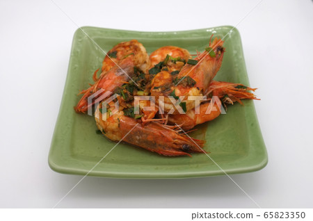 Fried shrimp with garlic on white background Fried shrimp with garlic on white background 65823350