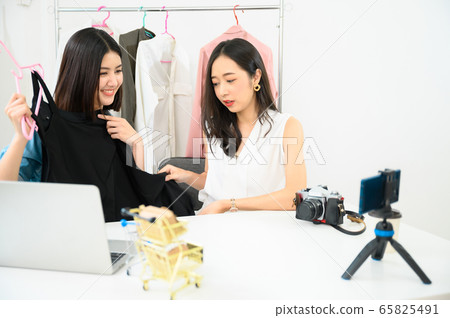 Two people young asian female recording video by smartphone for sale product online shopping Two people young asian female recording video by smartphone for sale product online shopping 65825491