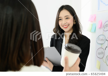 Two beautiful young asian business woman people have fun and talking Two beautiful young asian business woman people have fun and talking 65825494