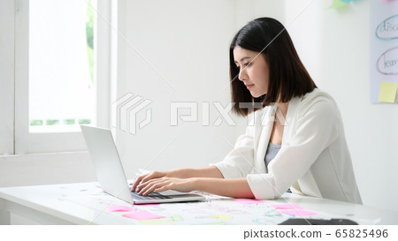 Young asian business woman working on computer laptop in office room 65825496