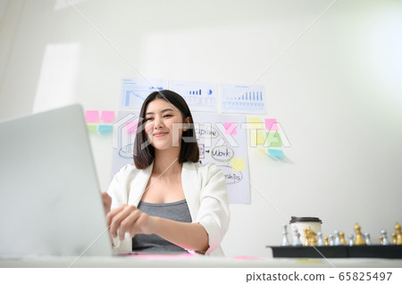 Young asian business woman working on computer laptop in office room Young asian business woman working on computer laptop in office room 65825497