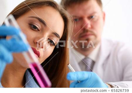 Technician hold in arms in protective gloves sample bottle Technician hold in arms in protective gloves sample bottle 65826739