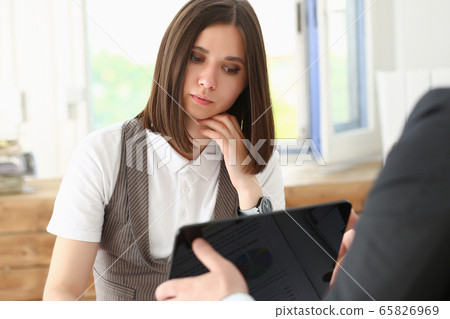 Businesswoman look at tablet pc in office Businesswoman look at tablet pc in office 65826969