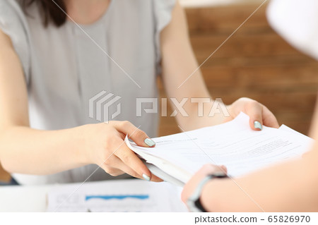 Female employee show pack of documents to manager Female employee show pack of documents to manager 65826970