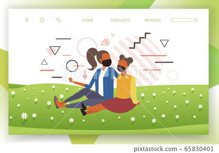 girls sitting on grass women wearing medical masks to prevent coronavirus pandemic quarantine concept girls sitting on grass women wearing medical masks to prevent coronavirus pandemic quarantine concept 65830401