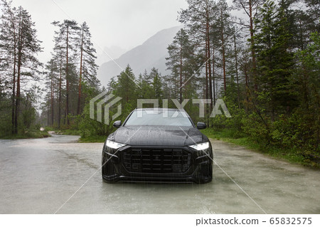 Sporty black crossover car in water Sporty black crossover car in water 65832575