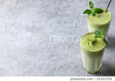 Two glasses of Dalgona Matcha latte tea. Close up. 65833762