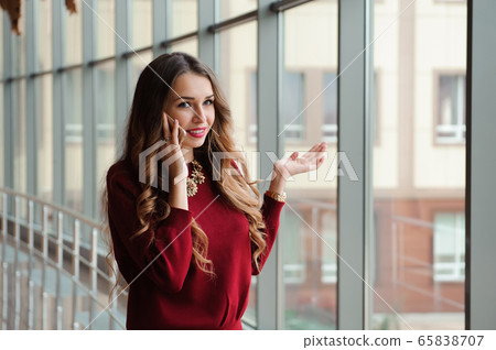 Young businesswoman with mobilephone. Young businesswoman with mobilephone. 65838707