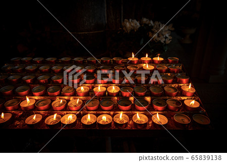 Tea light - Votive candles in a dark Christian church 65839138