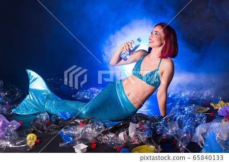Ocean plastic pollution concept. Mermaid lives to polluted habitat. 65840133