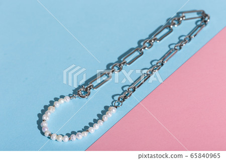 Women's Jewelry. Trendy jewelry on coloured background. Flat lay, top view. Women's Jewelry. Trendy jewelry on coloured background. Flat lay, top view. 65840965
