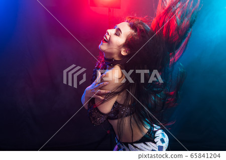 Belly dancer. Young attractive woman dancing tribal fusion on the stage. Oriental exotic dance. 65841204