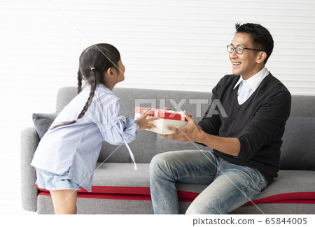 Asian daughter give present for father.fathers day 65844005