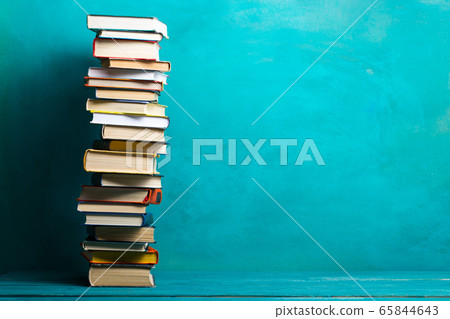 Composition with vintage old hardback books, diary, fanned pages on wooden deck table and abstract background. Books stacking. Back to school. Copy Space. Education background. Composition with vintage old hardback books, diary, fanned pages on wooden deck table and abstract background. Books stacking. Back to school. Copy Space. Education background. 65844643