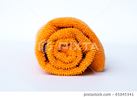 roll orange towel placed on white background roll orange towel placed on white background 65845341