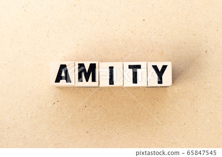 Letter block in word amity on wood background Letter block in word amity on wood background 65847545