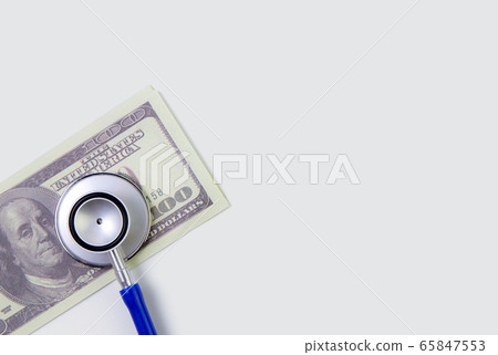 Stethoscope and paper dollar currency isolated on white background, medical insurance of finance Stethoscope and paper dollar currency isolated on white background, medical insurance of finance 65847553
