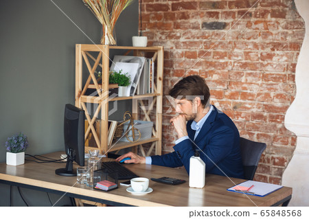 Young man, manager, team led return to work in his office after quarantine, feels happy and inspired 65848568