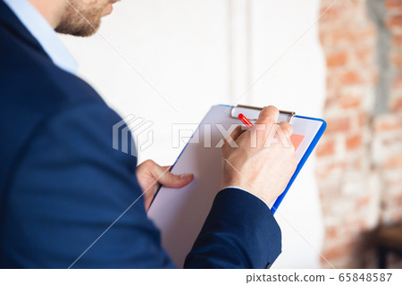 Close up young man, manager, team led return to work in his office after quarantine, feels happy and inspired 65848587