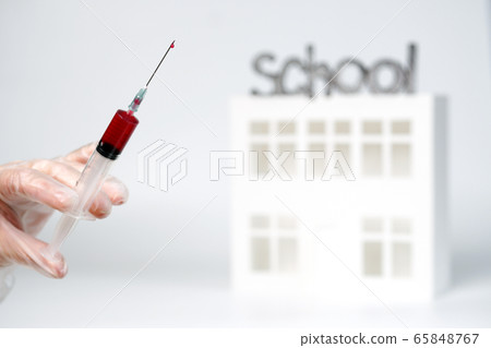 doctor hand in a glove holds a syringe with doctor hand in a glove holds a syringe with 65848767