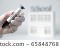 doctor  hand in a glove holds a test tube with 65848768