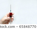 hand doctor in a glove holds a syringe with blood, 65848770