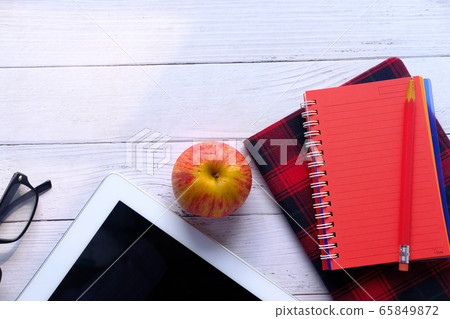 digital table, apple , notepad and pencil on table digital table, apple , notepad and pencil on table 65849872