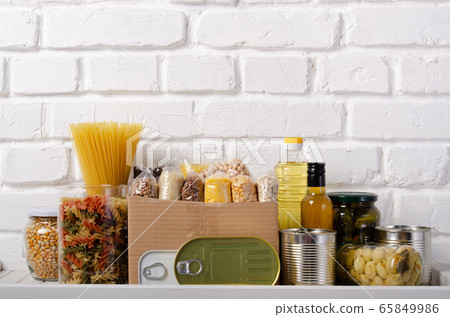 Set of uncooked foods on pantry shelf prepared for Set of uncooked foods on pantry shelf prepared for 65849986