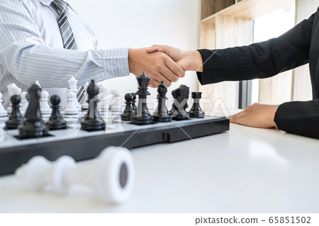 Businessman and businesswoman shaking hands after Businessman and businesswoman shaking hands after 65851502