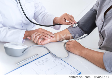 Doctor using a measuring blood pressure checking 65851557