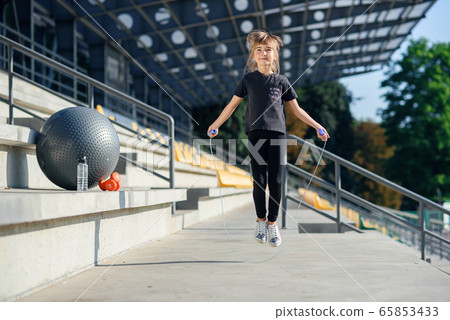 happy girl jumping with skipping rope outdoor happy girl jumping with skipping rope outdoor 65853433