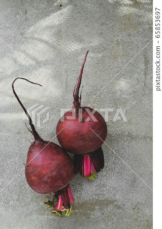 Summer harvest. Beets on a concrete background. Whole beets. Top view. Free space for text. Tasty and healthy vegetables. Concrete background Summer harvest. Beets on a concrete background. Whole beets. Top view. Free space for text. Tasty and healthy vegetables. Concrete background 65853697