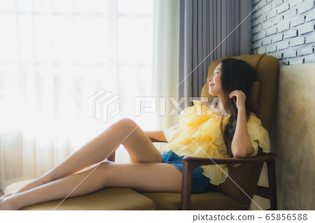 Portrait young asian woman relax happy smile on sofa chair in living room Portrait young asian woman relax happy smile on sofa chair in living room 65856588