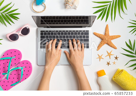 Working vacation them with laptop and beach items Working vacation them with laptop and beach items 65857233