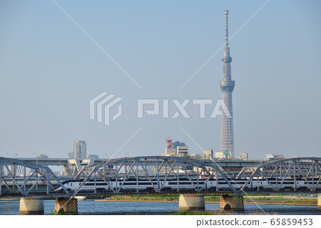 Keisei Skyliner crossing the Sky Tree and Arakawa Bridge 65859453