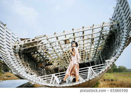 Thai woman on a part of an airplane. Thai woman on a part of an airplane. 65860398