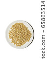 Organic food. Pine nuts on a white background. Cedar nuts flatlay on a white saucer. Agricultural concept. Superfood, top view, copy space. Banner vertical format with empty space for your text 65863514