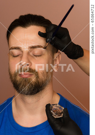 Tinting brows. Man 65864712