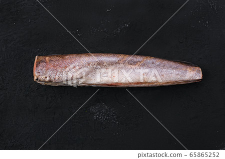 Raw hake on black background Raw hake on black background 65865252