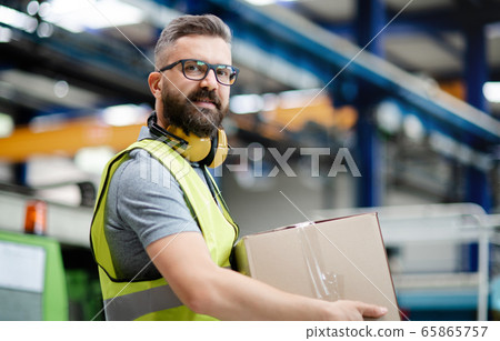 Man worker working in industrial factory or warehouse. 65865757