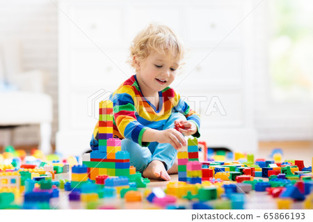 Child playing with toy blocks. Toys for kids. 65866193