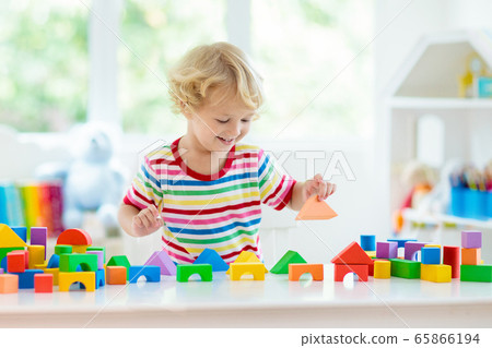 Kids toys. Child building tower of toy blocks. Kids toys. Child building tower of toy blocks. 65866194